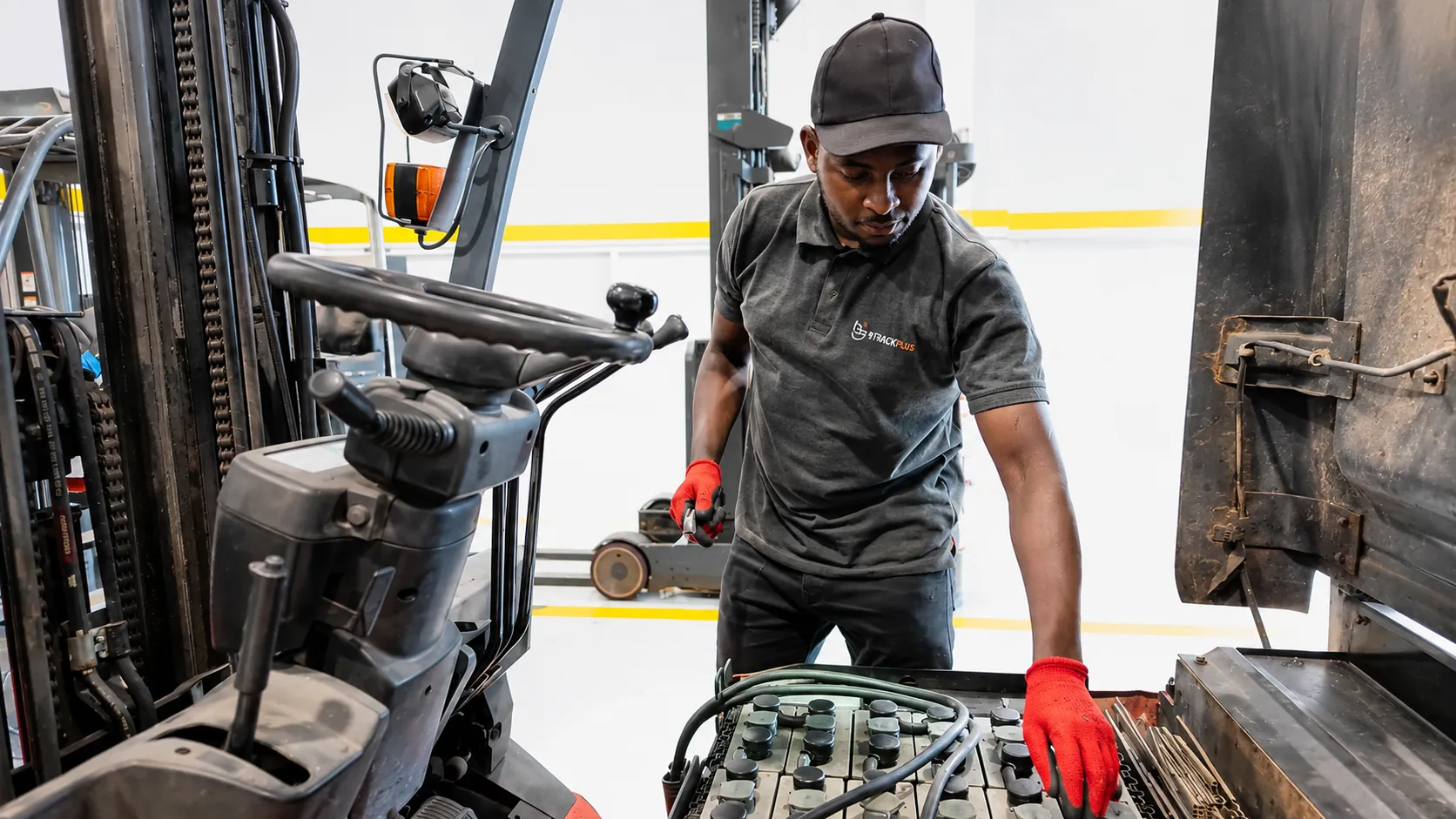Technician inspecting a forklift battery